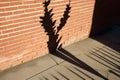 long shadow of a key falling on a vertical arrangement of bricks