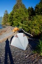 Long shadow of the photogragher on the beach beside 2 tents. Royalty Free Stock Photo