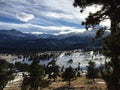 Long shadows and clouds over snow capped mountain peaks. Royalty Free Stock Photo