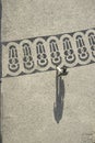 Long shadows of people on a square with pattern of paving stones in Lisbon