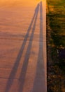 Long shadows of two people at sunset Royalty Free Stock Photo