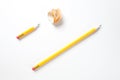 Long and a short pencil on textured white paper Royalty Free Stock Photo