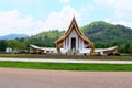 Long shot of a beautiful white Buddhist temple with dragon fountains at Ban Nong Chaeng, Phetchabun Thailand.