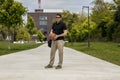 Long Shot of Casually Dressed Man With a Basketball and Gym Bag
