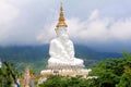 Long shot of five sitting white Buddhas and the foggy hills behind the Buddha at Pha Sorn Kaew, in Khao Kor, Phetchabun, Thailand.