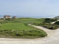 Long shot of an ocean front golf green and flag Royalty Free Stock Photo