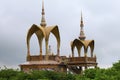 Long shot of two arched domes and a sitting Buddha, at Pha Sorn Kaew, in Khao Kor, Phetchabun, Thailand.