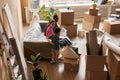 Long shot of young intercultural couple and their little son relaxing on couch