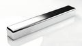 Long silver rectangular object on white surface Royalty Free Stock Photo