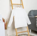 Long sleeve shirt hanged on to a ladder with minimalistic decorations Royalty Free Stock Photo