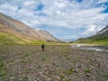 Long solo hike in the highlands. Heavy climb in the mountains with a big backpack. Travel lifestyle, hiking hard track, adventure