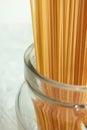 Long spaghetti in glass jar. Ingredient for Italian pasta. Raw food with selective focus Royalty Free Stock Photo