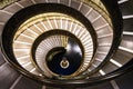 Long spiral, winding stairs. Dark shadows, mysterious mood Royalty Free Stock Photo