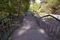 Long stairs to descend from the hill in the city park Royalty Free Stock Photo