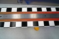 Long steel ruler attached to a surface