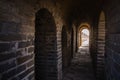 Long stone corridor with stairway in ancient castle or wall Royalty Free Stock Photo