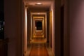 Long straight corridor of a hotel hotel with dark lighting Royalty Free Stock Photo