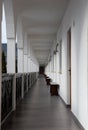 Long, straight corridor with white walls