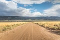 Long straight dirt road in Utah with dramatic clouds Royalty Free Stock Photo