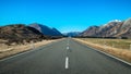 Long straight road leading towards a snow capped mountain in New Zealand Royalty Free Stock Photo