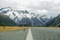 A long straight road leading towards a snow capped mountain in New Zealand Dramatic Royalty Free Stock Photo