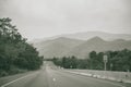 Long straight road with mountain view of countryside Royalty Free Stock Photo