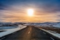 A long straight road at sunset in winter