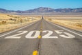 Long, straight road with 2025 written on the asphalt