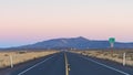Long straight stretch of US highway 20 in central Oregon High Desert at dusk Royalty Free Stock Photo