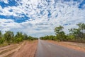 Long straight two lane road in Australian outback with trees on roadside Royalty Free Stock Photo