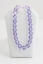 Long strand of large oblong faceted purple beads Royalty Free Stock Photo