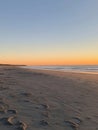 Vast empty beach at sunset with a serene horizon and peaceful sand stretching into the distance Generative AI Royalty Free Stock Photo