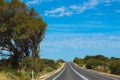 Long stretch of road in the Australian outback during a summer road trip Royalty Free Stock Photo