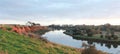 long stretching bend in a river that flows past red rock cliffs and into the ocean at Werribee south during golden hour, Victoria