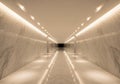 A long, symmetrical corridor with white marble walls and floor, featuring grey veining patterns. Royalty Free Stock Photo