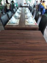 long table with neatly arranged chairs and dining arrangement of plates and bowls