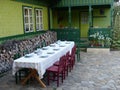 Long table prepared out of a green wood house in Romania. Royalty Free Stock Photo