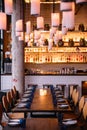 Long table with ten seats for dining at the restaurant with cozy and warm lighting in Bangkok, Thailand Royalty Free Stock Photo