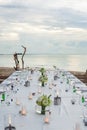 Long table wedding dinner setup on the beach. Royalty Free Stock Photo