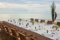 Long table wedding dinner setup on the beach. Royalty Free Stock Photo