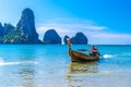 Long tail boat in bay of sea with rocks cliffs in background, Tonsai Bay, Railay Beach, Ao Nang, Krabi, Andaman sea, Thailand Royalty Free Stock Photo