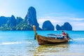 Long tail boat in bay of sea with rocks cliffs in background, Tonsai Bay, Railay Beach, Ao Nang, Krabi, Andaman sea, Thailand Royalty Free Stock Photo