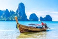 Long tail boat in bay of sea with rocks cliffs in background, Tonsai Bay, Railay Beach, Ao Nang, Krabi, Andaman sea, Thailand Royalty Free Stock Photo