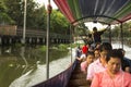 A long-tail boat carrying local people passing on the Chao Praya River.