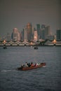 Long tail boat in chaopraya river and bangkok skyscraper background