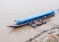 Long tail boat is floating near the local pontoon.