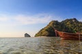 Long tail boat in front of twin sea island