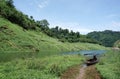 Long tail boat parking in the water in tropical forest Royalty Free Stock Photo