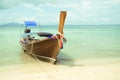 Long tail boat on the sand seashore