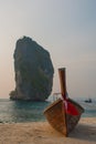 Long tail boat on tropical beach with limestone rock. Sunset, island Taming. Krabi, Thailand. Royalty Free Stock Photo